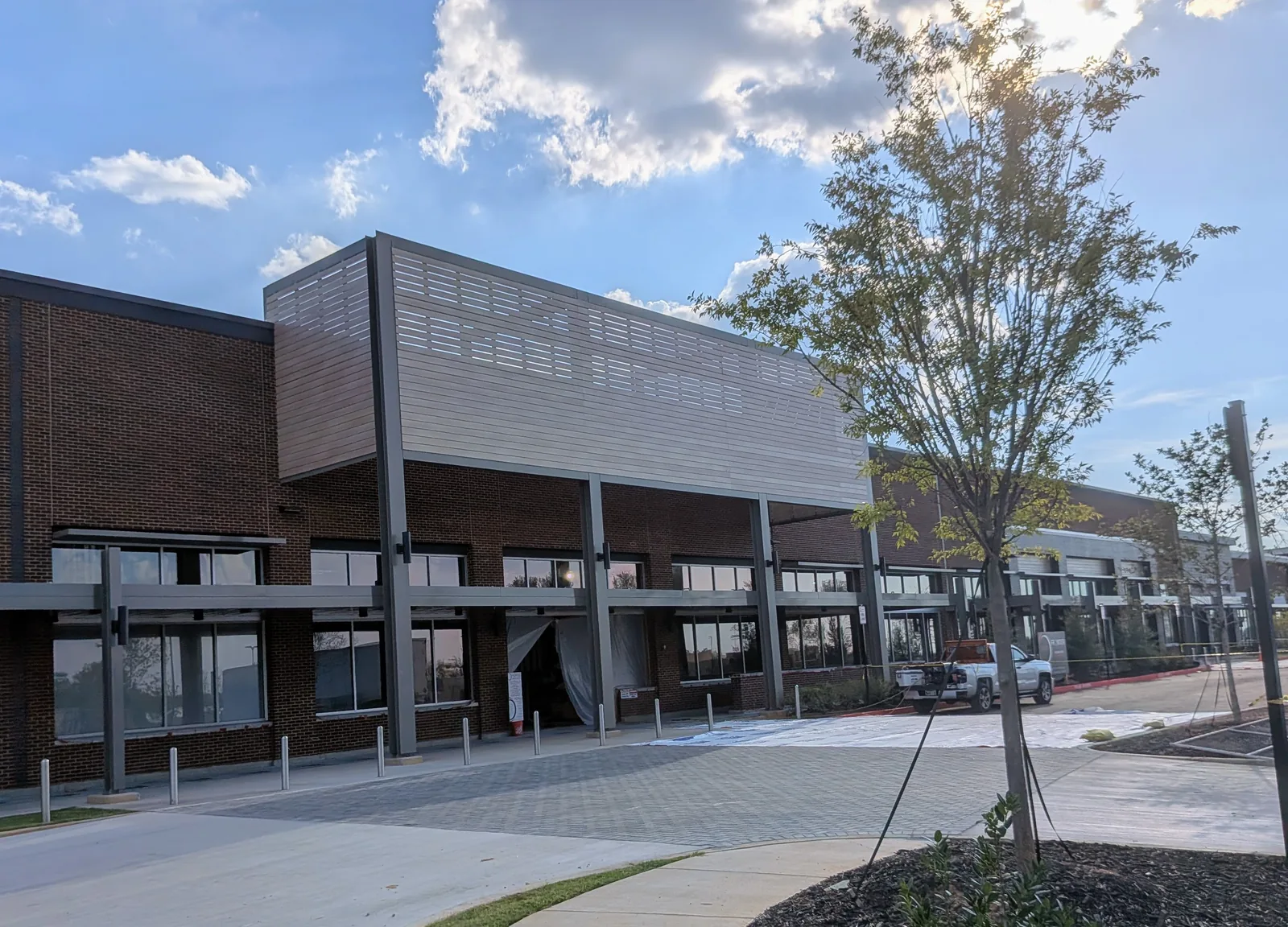Construction progress at the future Whole Foods anchor in Forsyth Town Center, with exposed brick, a partially built entrance canopy and paper-covered windows